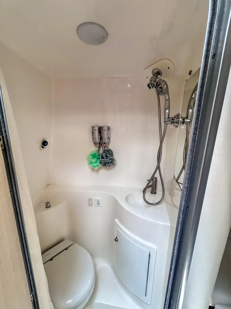 Slide: The Image of 2023 Regal 26 XO boat bathroom with shower and toilet. - 16