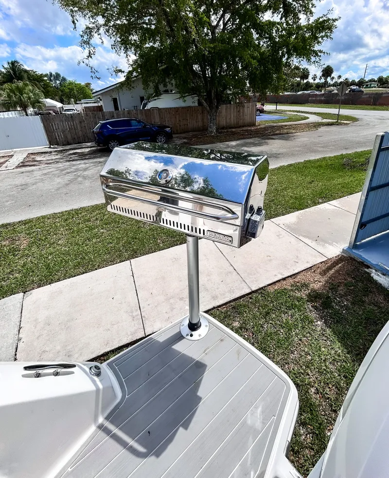 Slide: The Image of 2023 Regal 26 XO boat with a mounted stainless steel grill on deck. - 7