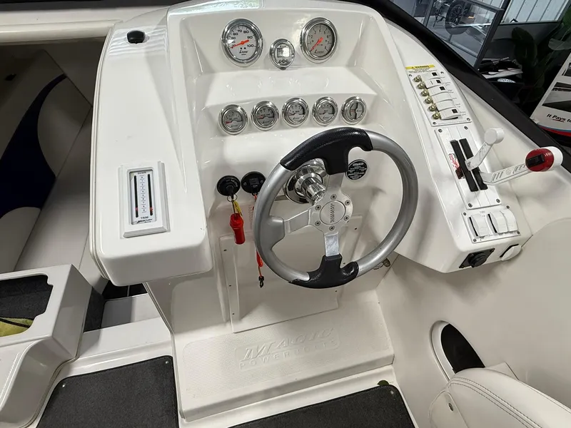 Slide: The Image of 2006 Magic 29 Wizard boat dashboard with steering wheel and gauges. - 13