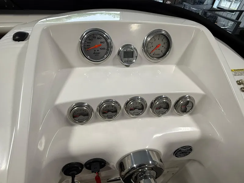 Slide: The Image of Dashboard of a 2006 Magic 29 Wizard boat with gauges and controls. - 14