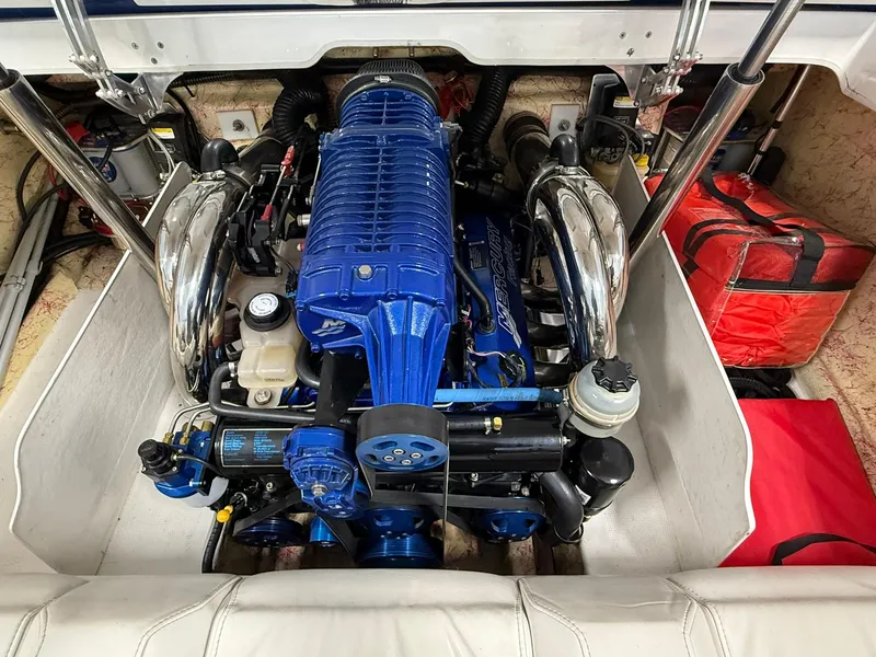 Slide: The Image of Engine compartment of a 2006 Magic 29 Wizard boat, featuring a blue engine. - 17