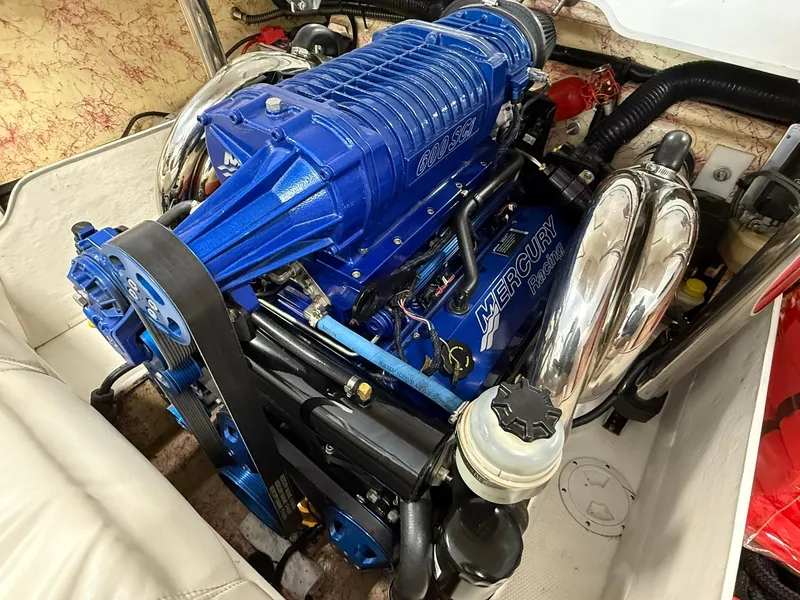 Slide: The Image of Blue Mercury engine in a 2006 Magic 29 Wizard boat, showcasing detailed components. - 18