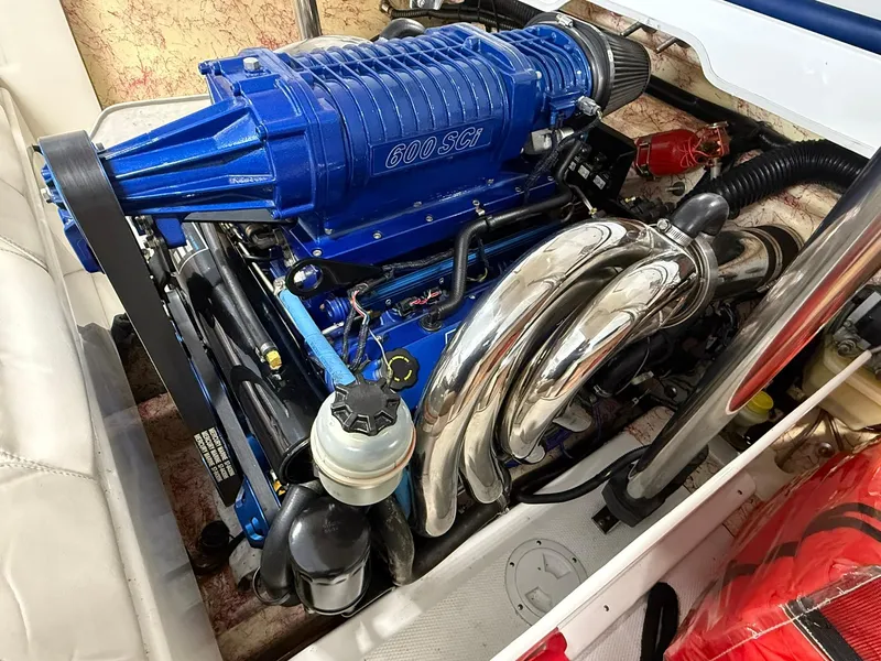 Slide: The Image of Powerful engine of a 2006 Magic 29 Wizard boat with blue 600 SCI supercharger. - 19