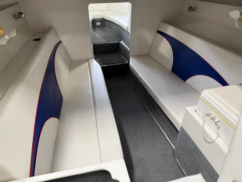 Slide: The Image of Interior of a 2006 Magic 29 Wizard boat with white and blue seating. - 21