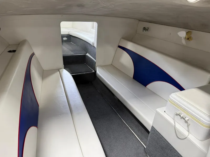 Slide: The Image of Interior of a 2006 Magic 29 Wizard boat with white and blue seating. - 23