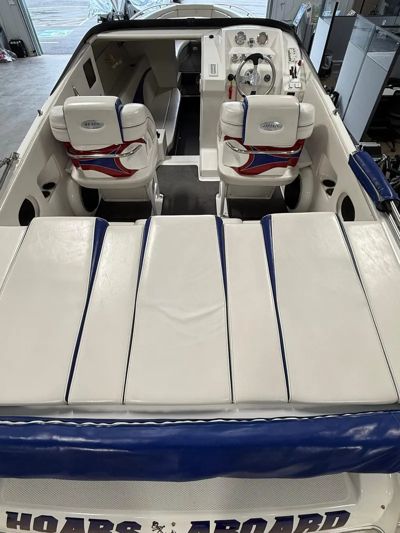 Slide: The Image of 2006 Magic 29 Wizard boat interior with white and blue seating. - 8