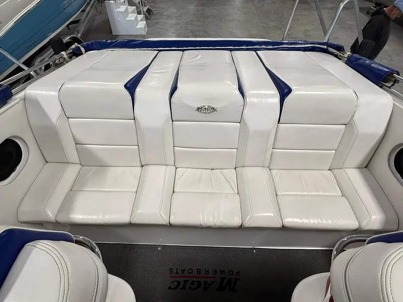 Slide: The Image of White leather seating on a 2006 Magic 29 Wizard boat, featuring blue accents. - 9