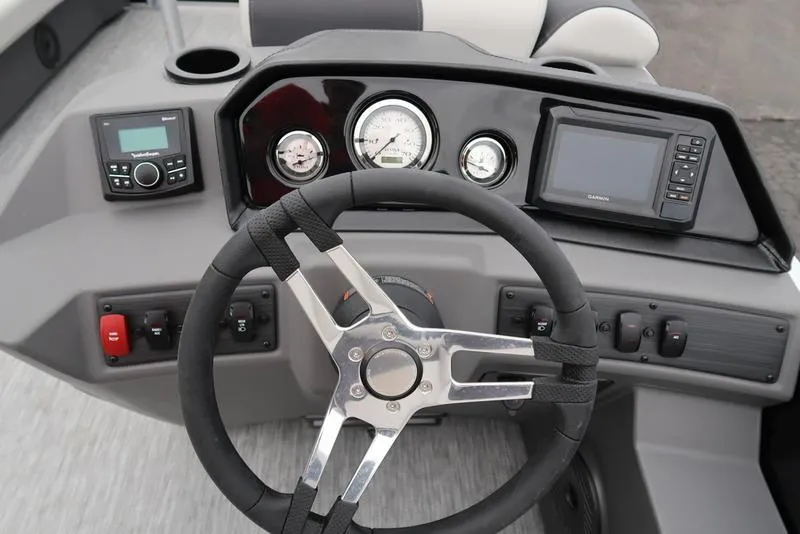 Slide: The Image of Steering console of 2025 Bennington S Swingback 22 SSB Limited with gauges and controls. - 12