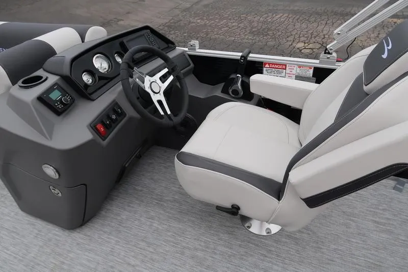 Slide: The Image of 2025 Bennington S Swingback 22 SSB Limited boat interior with steering console and captain's chair. - 13