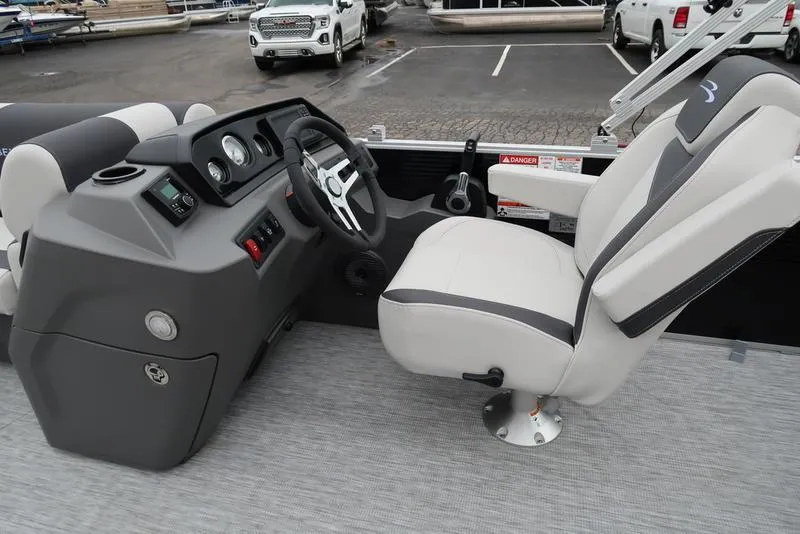 Slide: The Image of 2025 Bennington S Swingback 22 SSB Limited boat interior with steering console and captain's chair. - 15