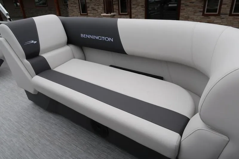 Slide: The Image of 2025 Bennington S Swingback 22 SSB Limited boat seating, featuring sleek gray and white upholstery. - 18