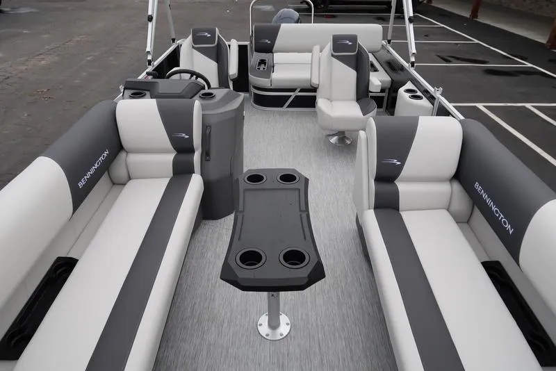 Slide: The Image of 2025 Bennington S Swingback 22 SSB Limited pontoon boat interior with gray seating and table. - 20