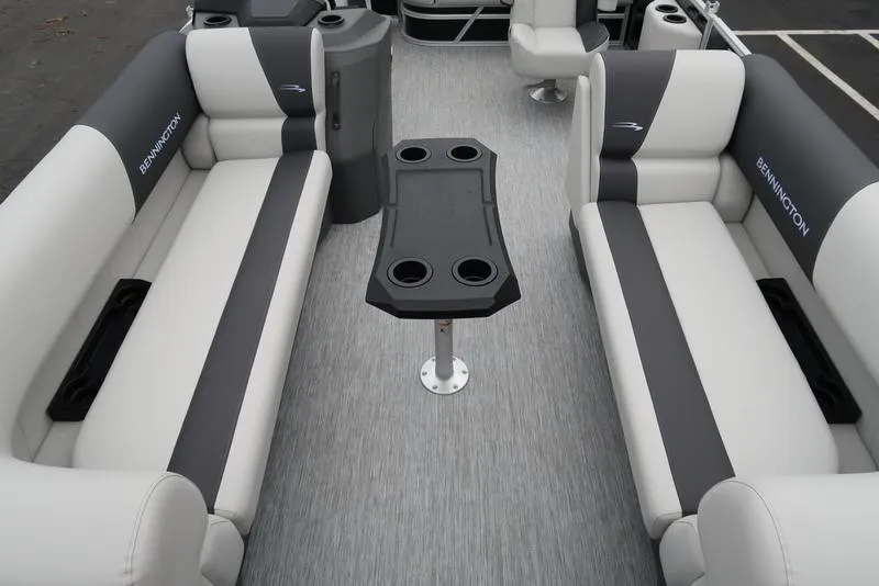 Slide: The Image of 2025 Bennington S Swingback 22 SSB Limited interior with gray seating and central table. - 21