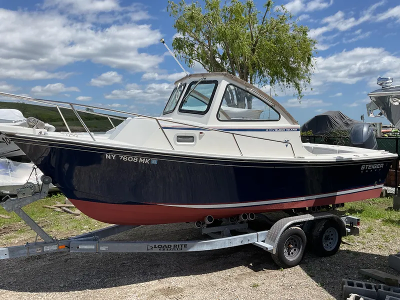 Slide: The Image of 2015 Steiger Craft 21 DV Block Island boat on trailer, under clear sky. - 0