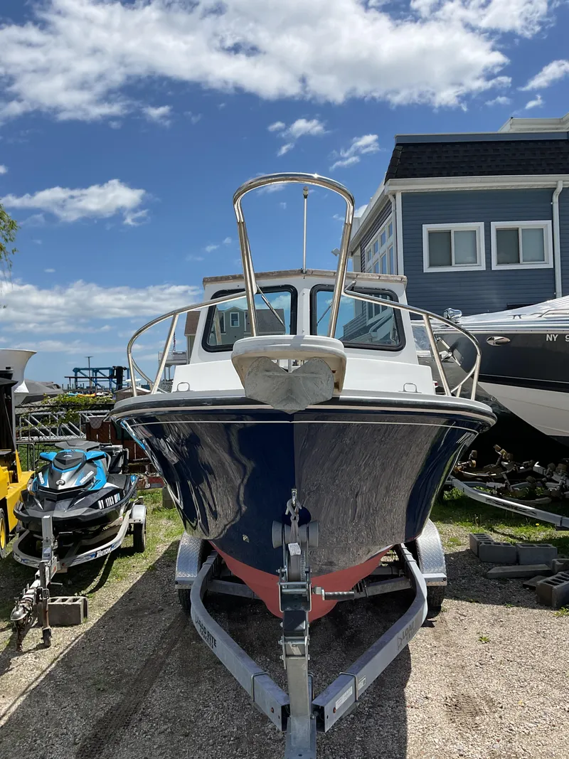 Slide: The Image of 2015 Steiger Craft 21 DV Block Island boat on trailer, parked outdoors under a blue sky. - 3