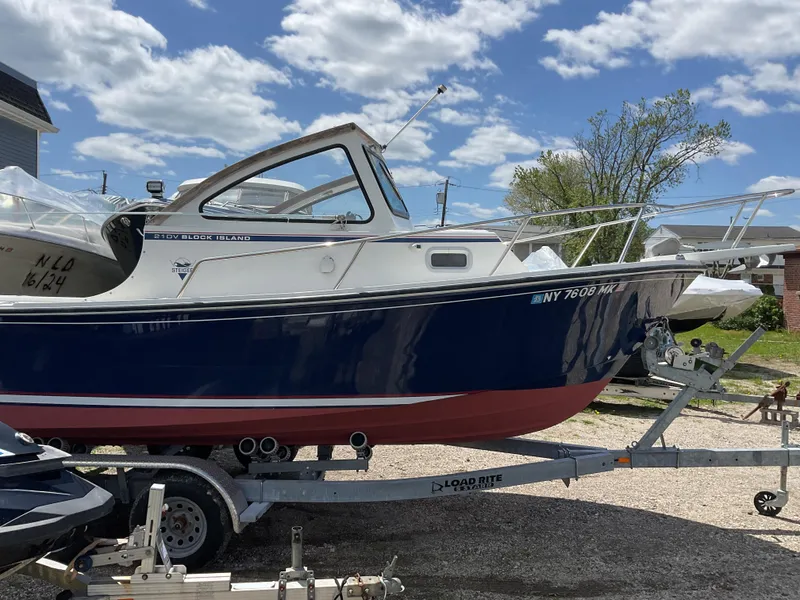 Slide: The Image of 2015 Steiger Craft 21 DV Block Island boat on trailer under a cloudy sky. - 6
