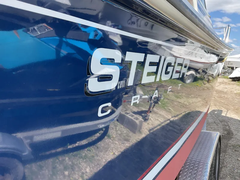 Slide: The Image of 2015 Steiger Craft 21 DV Block Island boat, blue hull with logo, parked outdoors. - 7