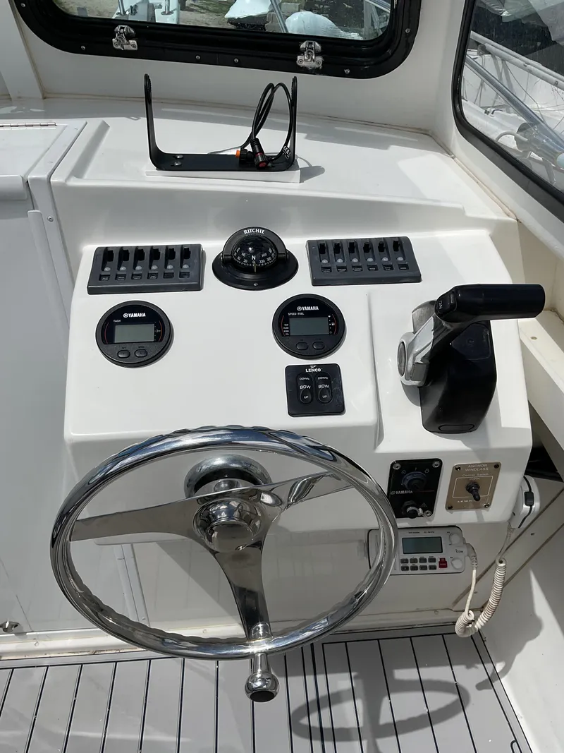 Slide: The Image of 2015 Steiger Craft 21 DV Block Island boat helm with steering wheel and controls. - 8