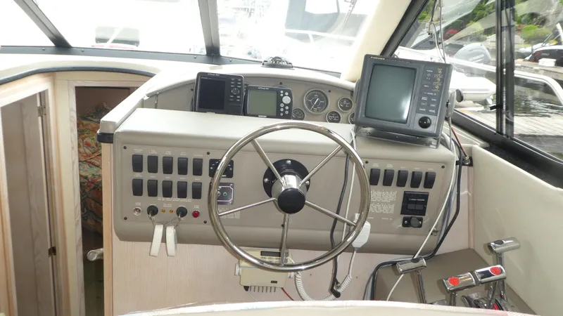 Slide: The Image of 1996 Bayliner 3488 Avanti Command Bridge helm with steering wheel and navigation equipment. - 10