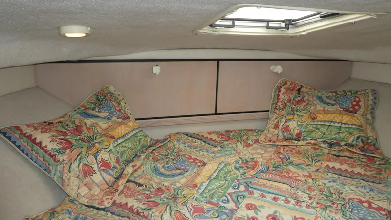 Slide: The Image of 1996 Bayliner 3488 Avanti Command Bridge cabin with colorful bedding and overhead hatch. - 15