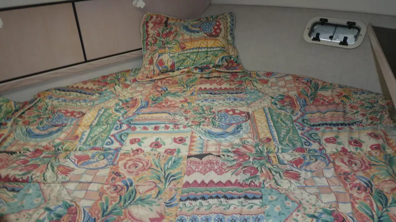 Slide: The Image of 1996 Bayliner 3488 Avanti Command Bridge cabin with colorful patterned bedding. - 16