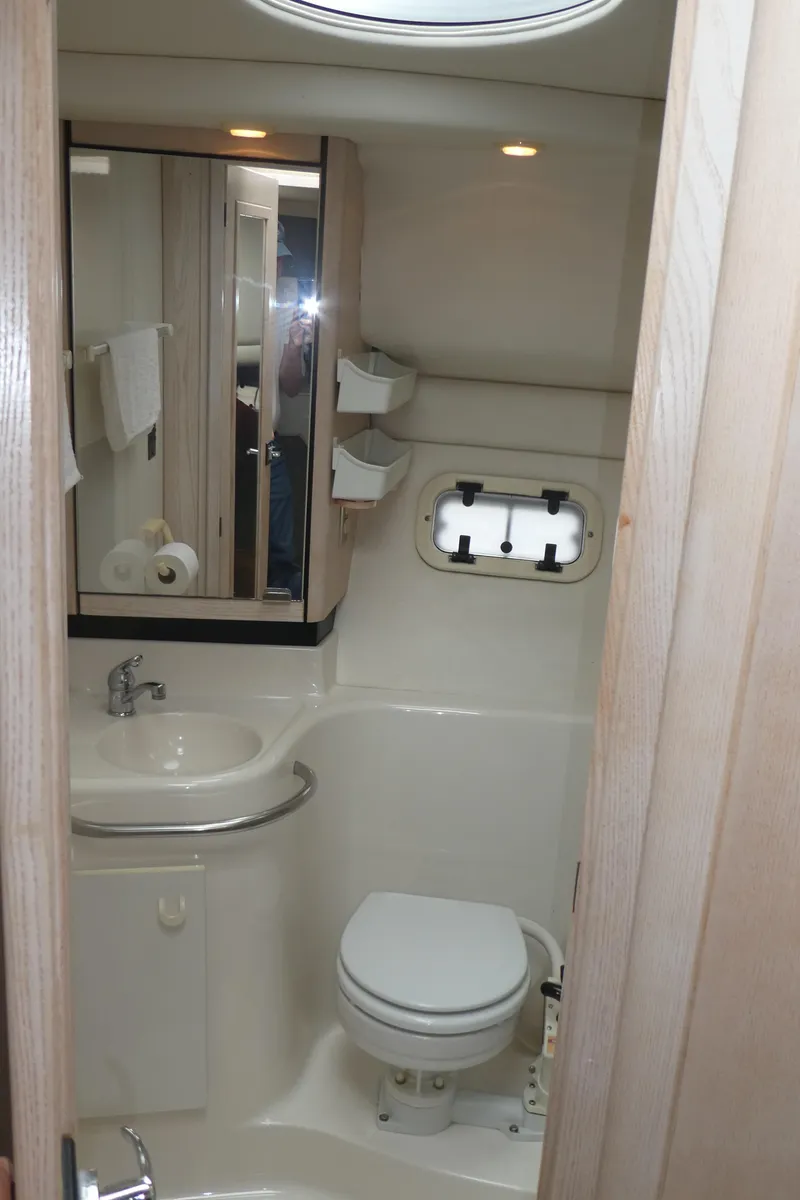 Slide: The Image of 1996 Bayliner 3488 Avanti Command Bridge bathroom with sink, toilet, and mirror. - 17