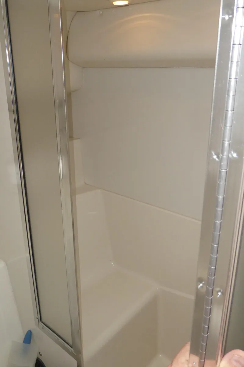 Slide: The Image of 1996 Bayliner 3488 Avanti Command Bridge shower area with sliding door. - 19
