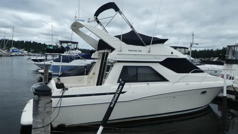 Slide: The Image of 1996 Bayliner 3488 Avanti Command Bridge docked at marina. - 2