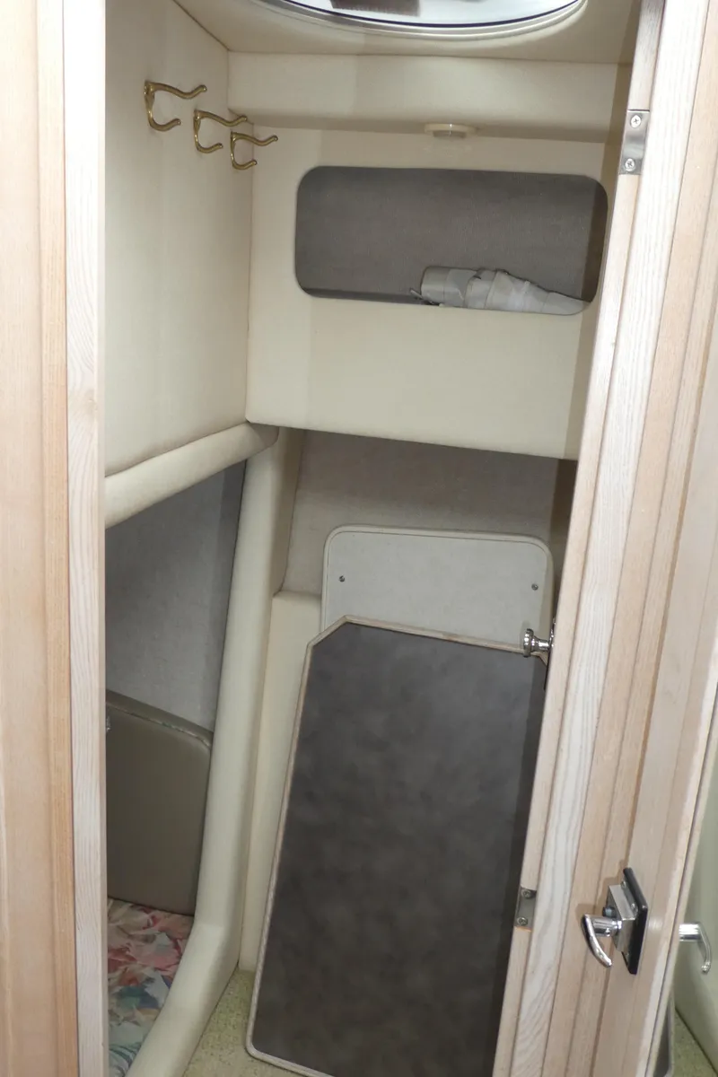 Slide: The Image of 1996 Bayliner 3488 Avanti Command Bridge cabin interior with storage and hooks. - 20