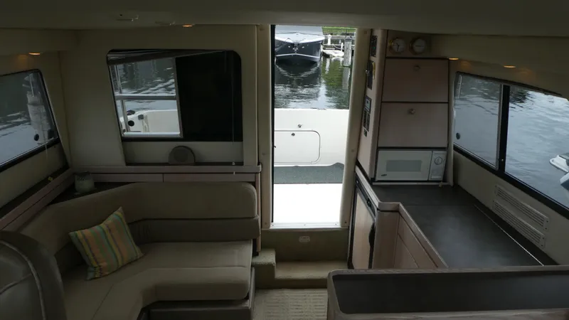Slide: The Image of Interior of 1996 Bayliner 3488 Avanti Command Bridge with seating and kitchenette. - 22