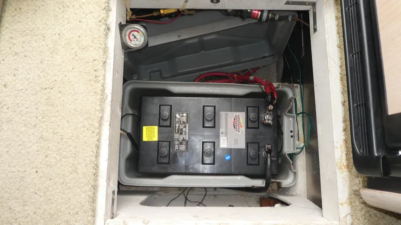 Slide: The Image of Battery compartment of 1996 Bayliner 3488 Avanti Command Bridge with visible wiring and gauge. - 24