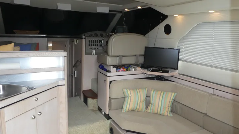 Slide: The Image of Interior of 1996 Bayliner 3488 Avanti Command Bridge with seating, TV, and kitchenette. - 26