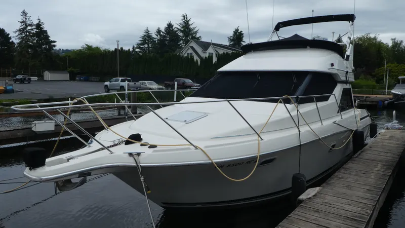 Slide: The Image of 1996 Bayliner 3488 Avanti Command Bridge docked at marina, side view. - 33