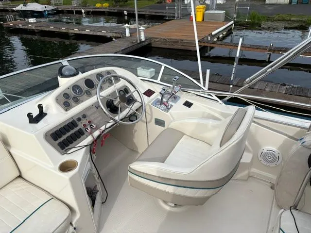 Slide: The Image of 1996 Bayliner 3488 Avanti Command Bridge helm with controls, docked at marina. - 34