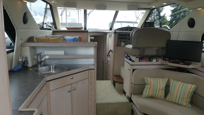 Slide: The Image of Interior of 1996 Bayliner 3488 Avanti Command Bridge with seating, helm, and kitchenette. - 5