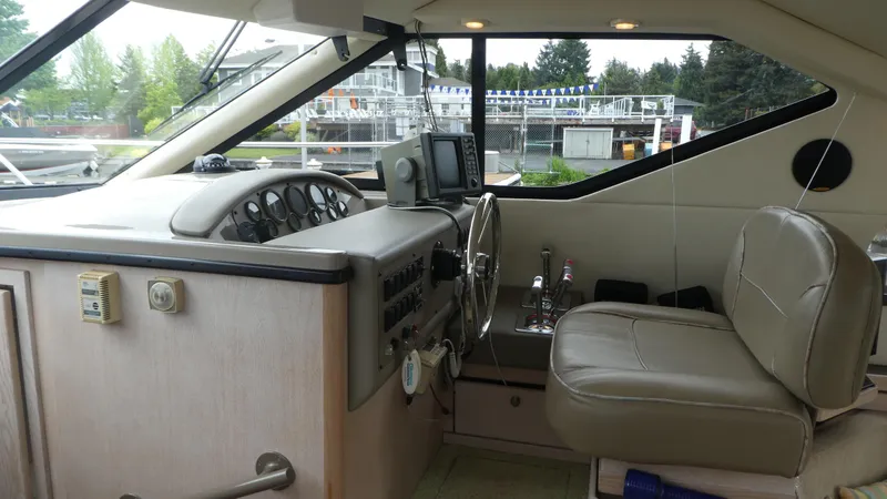 Slide: The Image of 1996 Bayliner 3488 Avanti Command Bridge interior with steering wheel and control panel. - 9