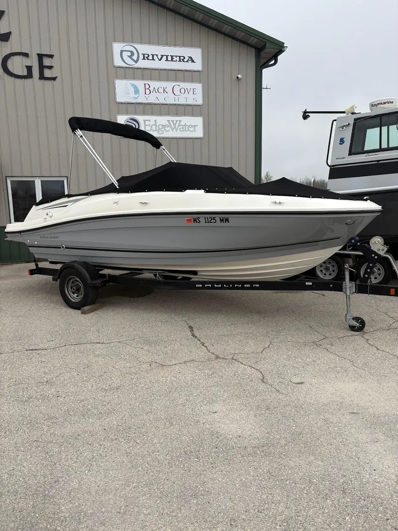 Slide: The Image of 2017 Bayliner VR5 Bowrider boat on trailer, parked outside a dealership. - 1