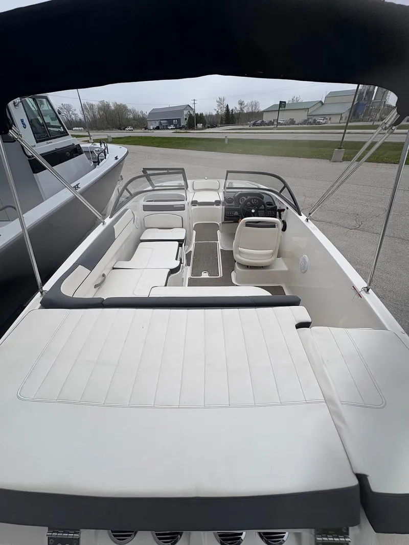 Slide: The Image of 2017 Bayliner VR5 Bowrider with spacious seating and canopy, parked outdoors. - 12