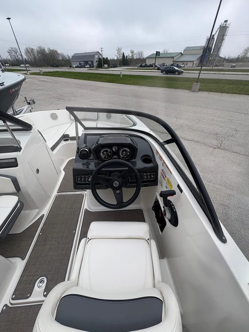 Slide: The Image of 2017 Bayliner VR5 Bowrider cockpit with steering wheel and dashboard controls. - 6