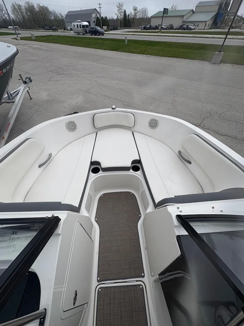 Slide: The Image of 2017 Bayliner VR5 Bowrider boat interior with white seating and gray flooring. - 8
