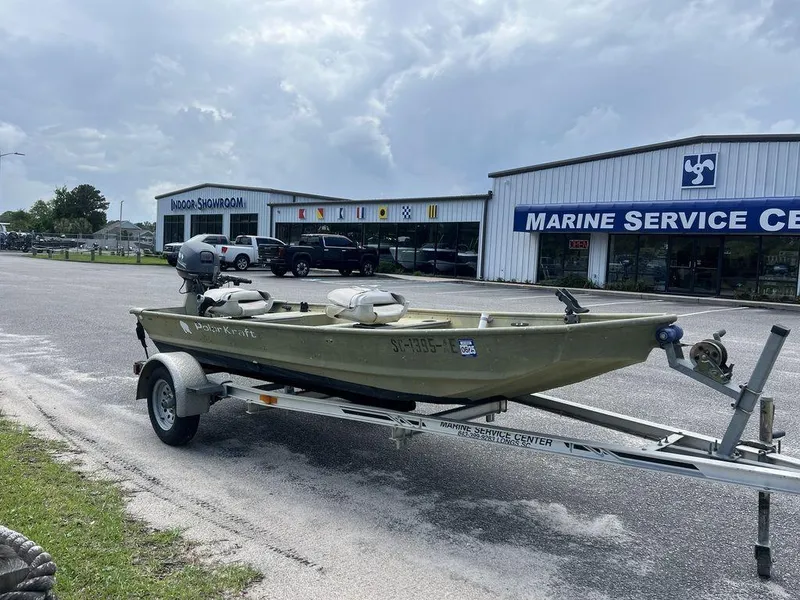 Slide: The Image of 1989 Polar Kraft 15' Jon boat on trailer outside marine service center. - 5