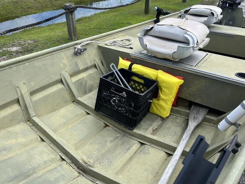 Slide: The Image of 1989 Polar Kraft 15' Jon boat interior with crate, oar, and life jackets. - 9