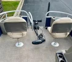 Slide: The Image of 2023 Sun Tracker Bass Buggy 18 DLX pontoon boat with two seats and trolling motor. - 2