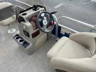 Slide: The Image of 2023 Sun Tracker Bass Buggy 18 DLX boat interior with steering console and seating. - 3