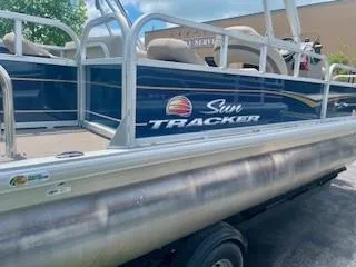Slide: The Image of 2023 Sun Tracker Bass Buggy 18 DLX pontoon boat with blue exterior and white railing. - 8