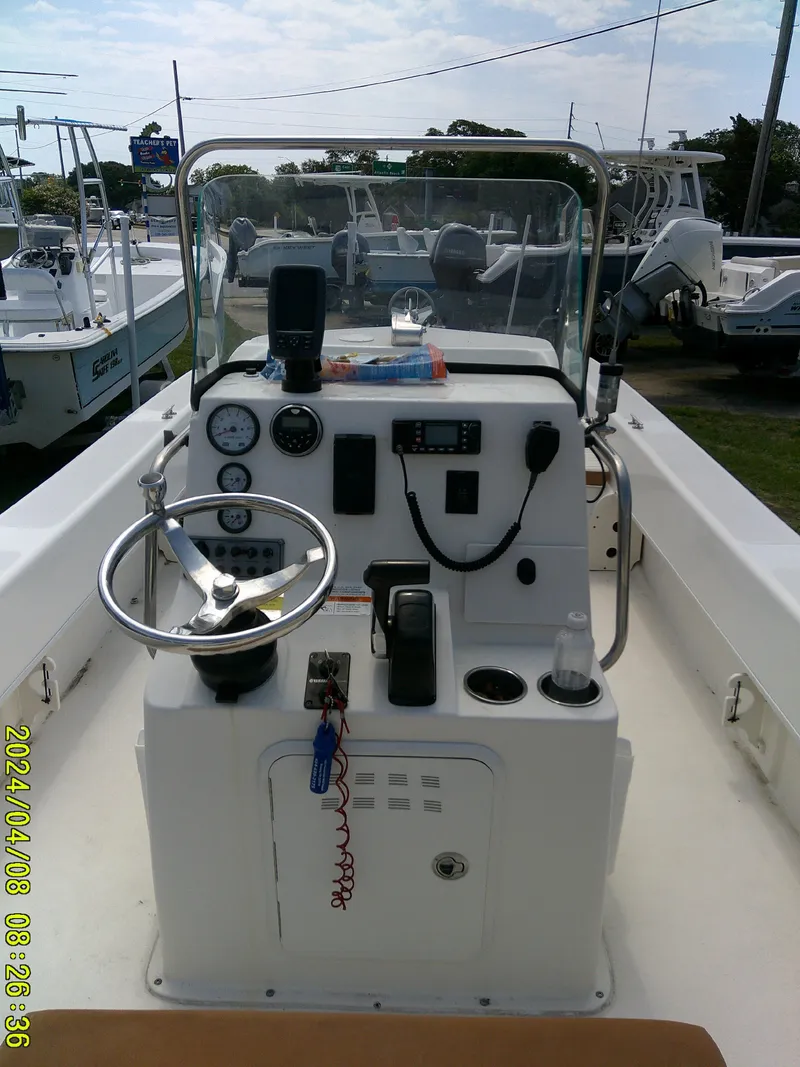 Slide: The Image of 2015 Sundance B22CCR boat dashboard with steering wheel and controls. - 15