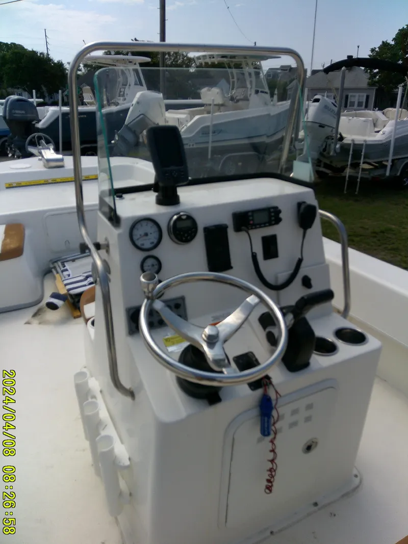 Slide: The Image of 2015 Sundance B22CCR boat console with steering wheel and gauges. - 16