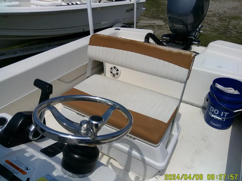 Slide: The Image of Sundance B22CCR 2015 boat interior with steering wheel and seating, dated April 8, 2024. - 19