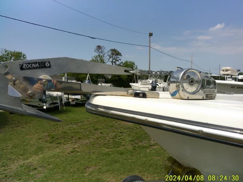 Slide: The Image of Sundance B22CCR 2015 boat with Rocna anchor, parked on grass, clear sky background. - 4