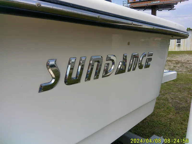 Slide: The Image of Sundance B22CCR boat, 2015 model, with chrome lettering on the hull. - 7